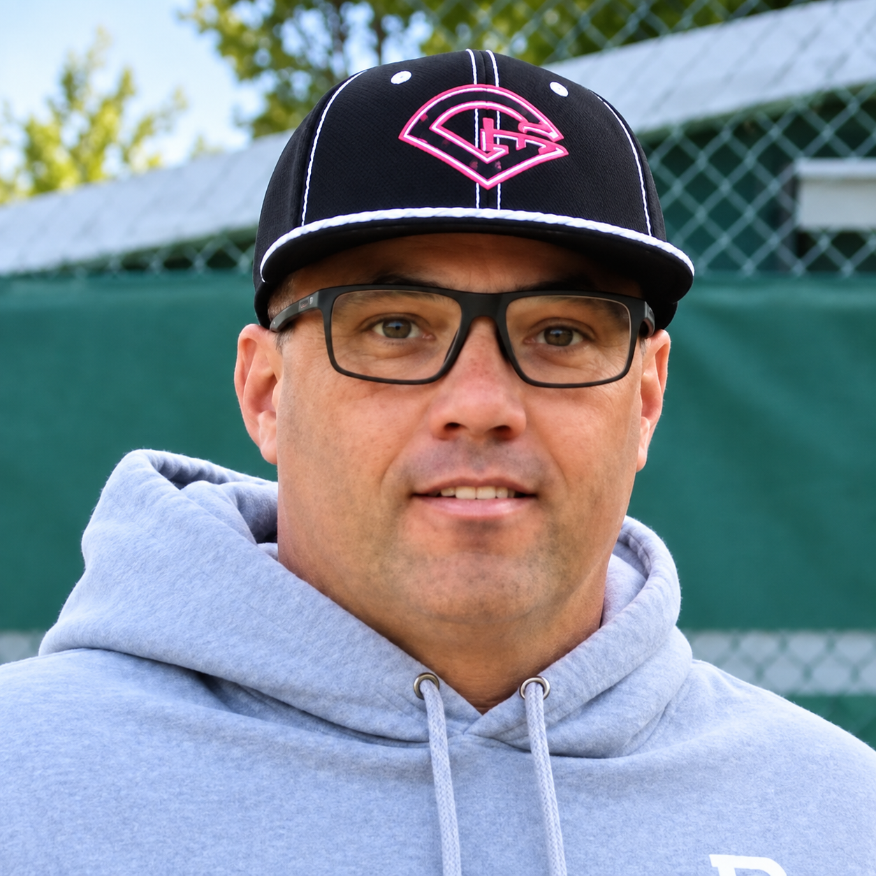 Coach Dustin Brundage outdoors at the field
